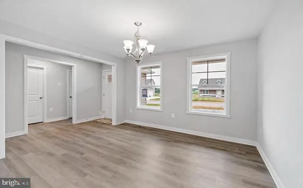 wooden floor in an empty room with a fireplace