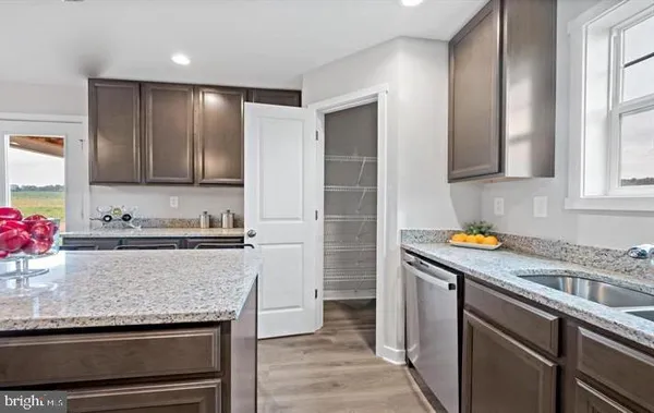 a kitchen with stainless steel appliances granite countertop a stove and a refrigerator