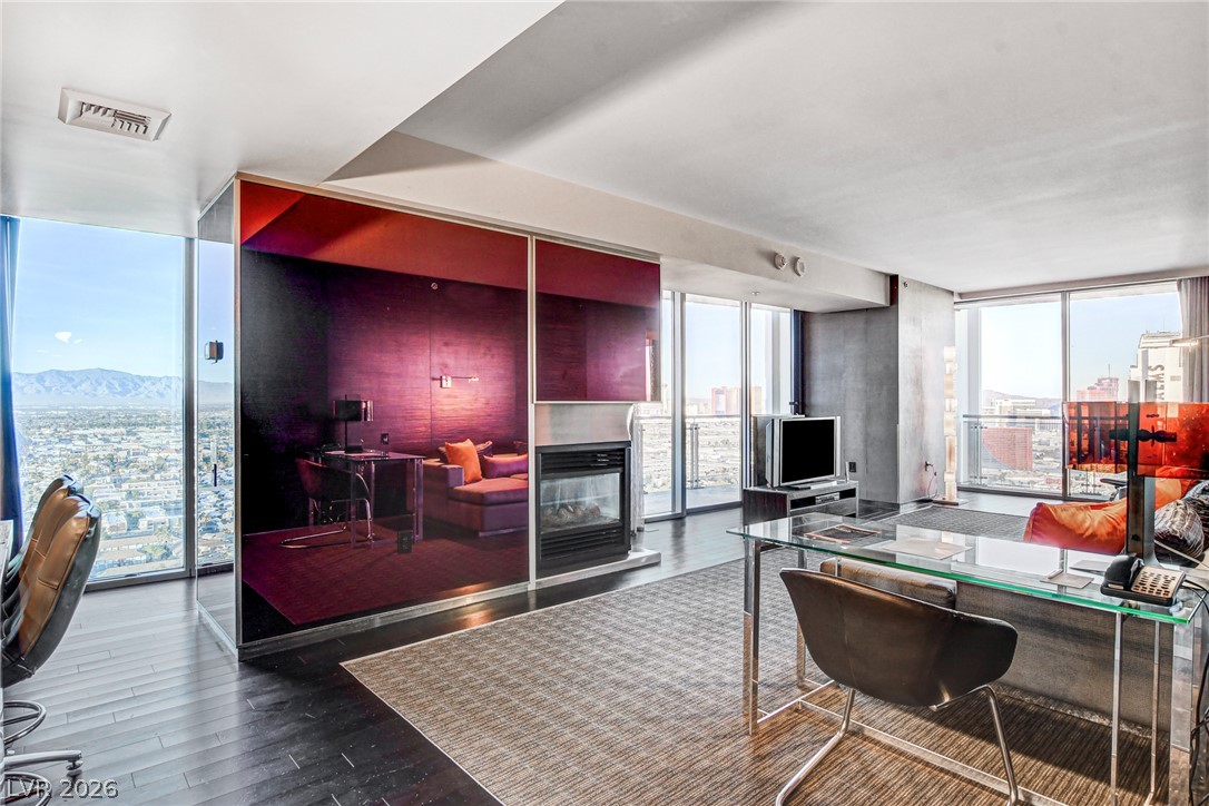 4381 West Flamingo Road, Unit 3002 Las Vegas, NV 89103 - Photo 43 of 59 Gleaming wood floors and a sleek modern fireplace define this light-filled high-rise interior.