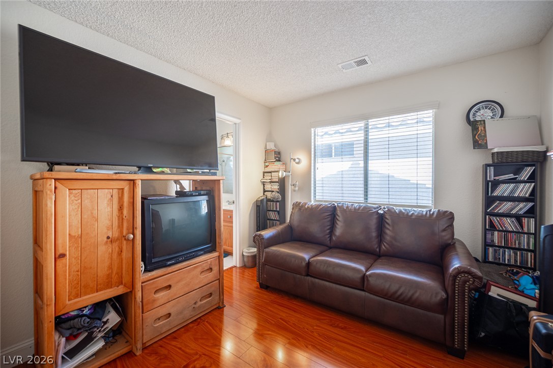 718 Rusty Spur Drive Henderson, NV 89014 - Photo 39 of 50 Rich hardwood floors create a warm and inviting atmosphere in this cozy living area.