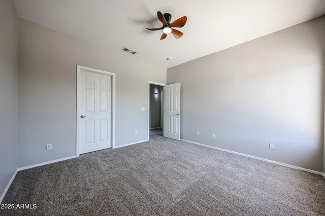a view of a room with a ceiling fan