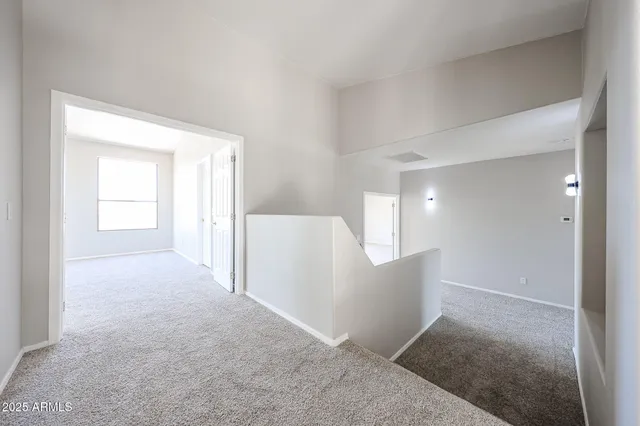 an empty room with windows and entrance