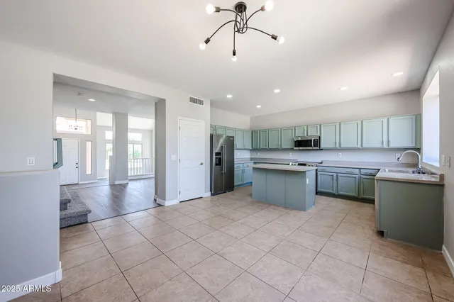 a large white kitchen with a stove a sink dishwasher and a refrigerator