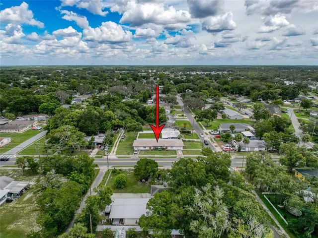 an aerial view of residential houses with outdoor space and street view