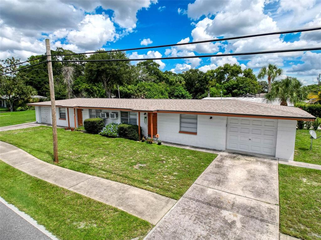 5800 Madison Street New Port Richey, FL 34653 - Photo 3 of 71 a front view of a house with a yard and garage
