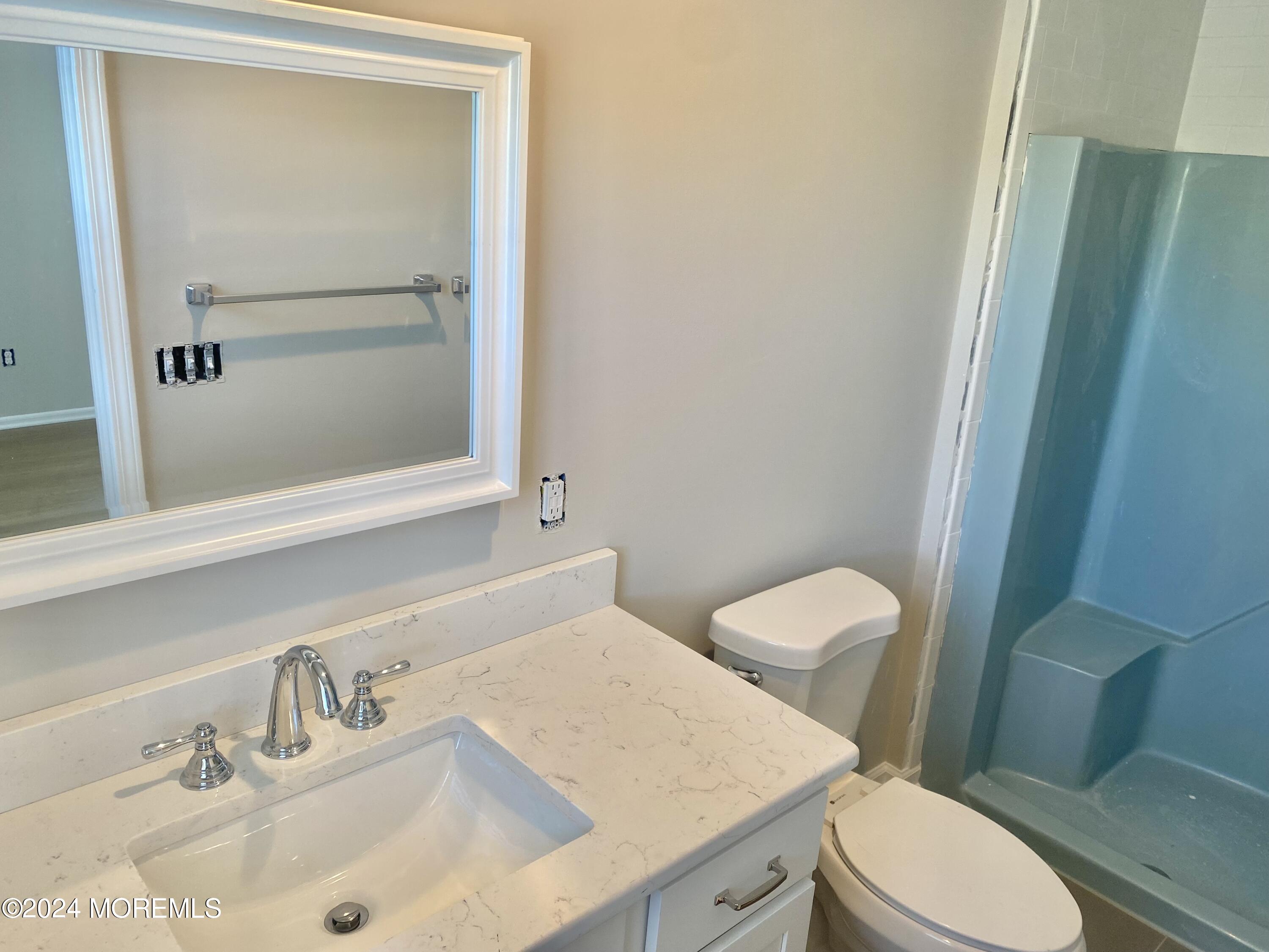 108 Chatham Lane, Unit B Point Pleasant, NJ 08742 - Photo 10 of 14 a bathroom with a sink a toilet and mirror