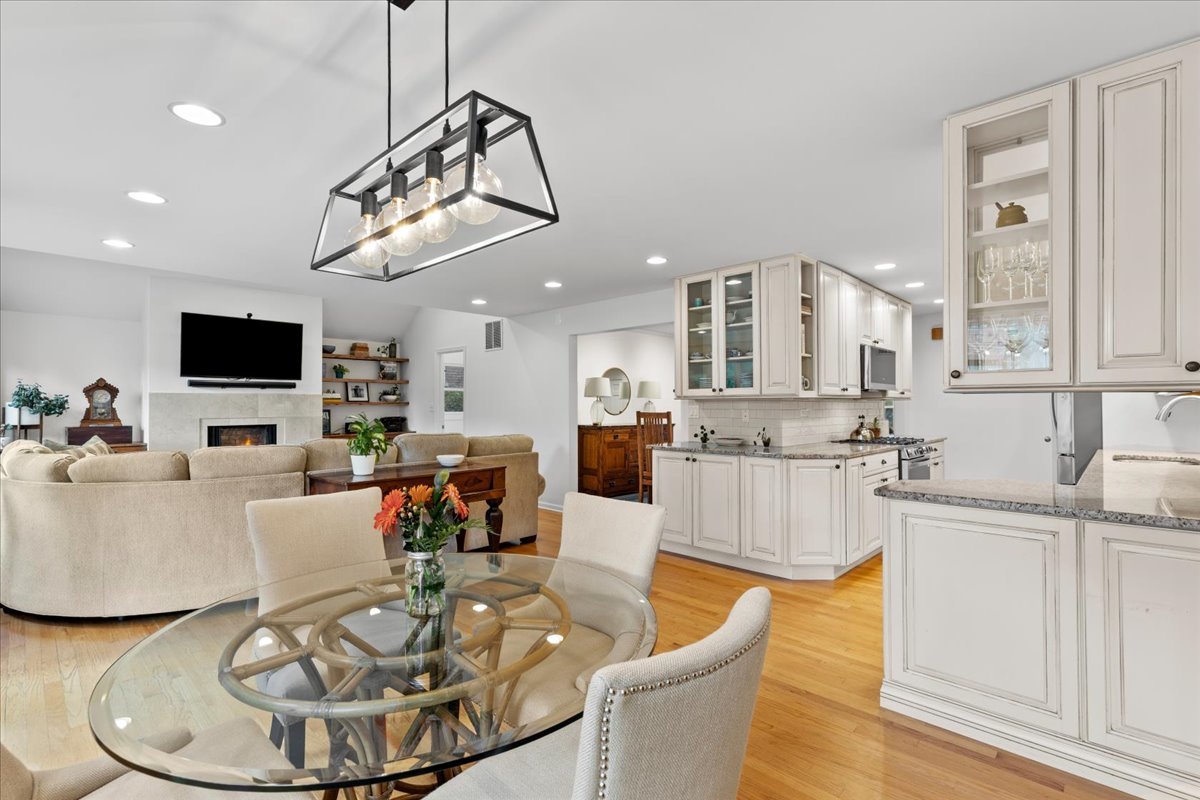 40 Williamsburg Road Evanston, IL 60203 - Photo 21 of 26 a living room with furniture a dining table and a chandelier