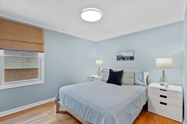 a bedroom with a bed and a lamp