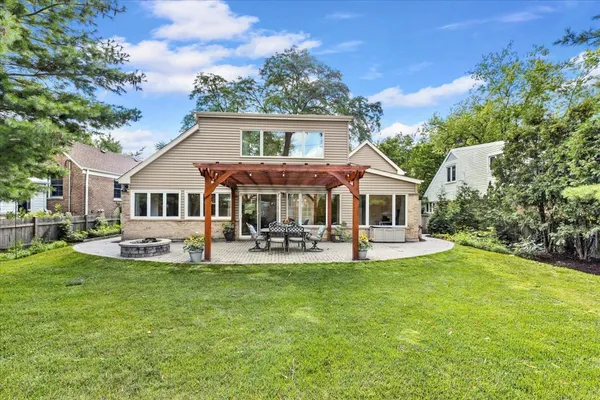 a view of a house with a yard and sitting area