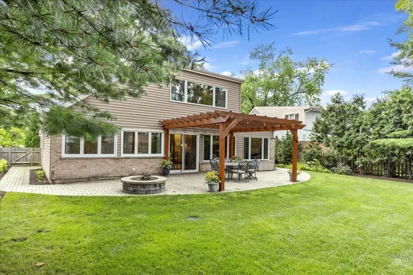 a front view of a house with garden and patio