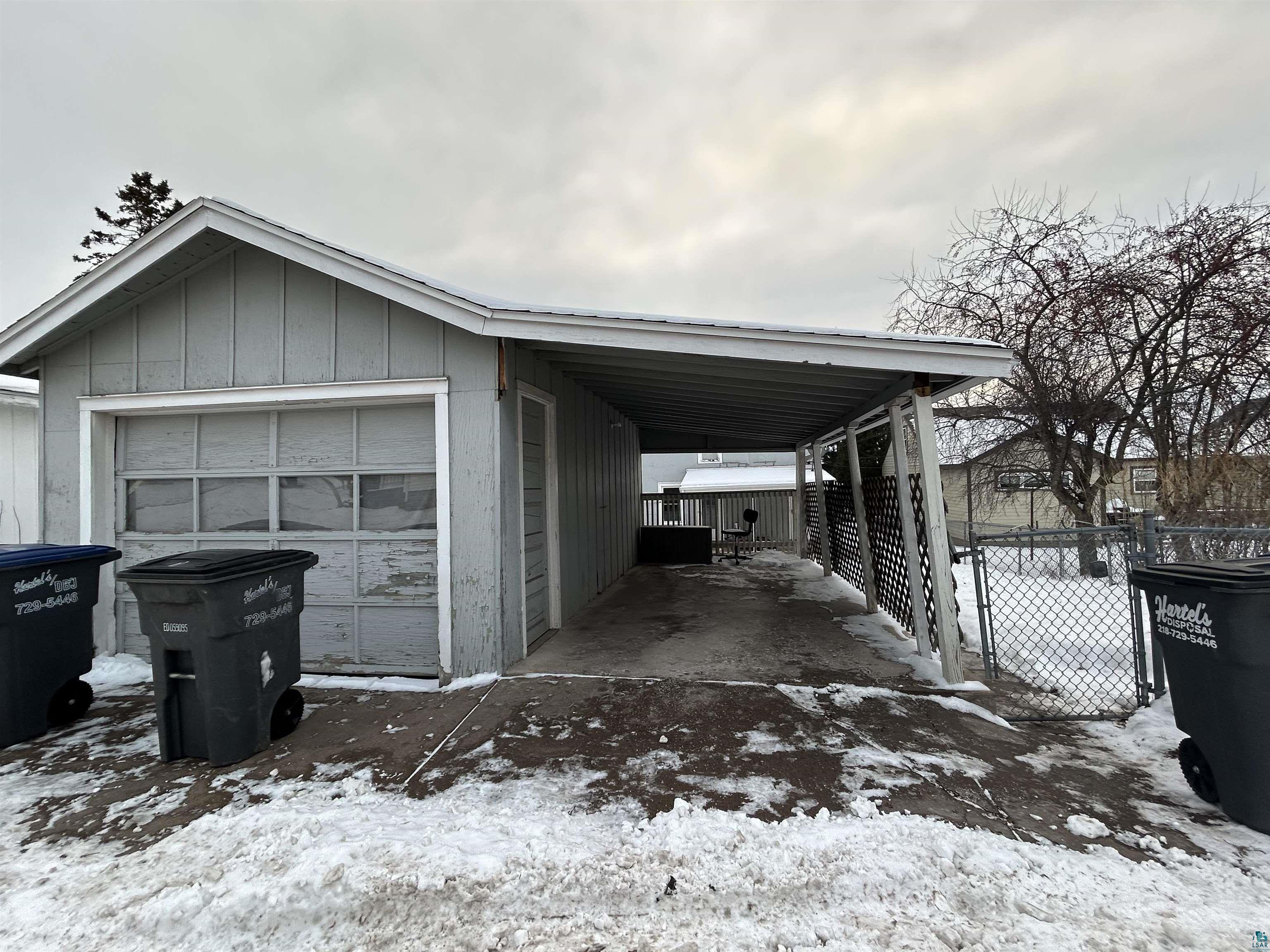 4405 West 7th Street Duluth, MN 55807 - Photo 12 of 18 Snow covered garage featuring a carport