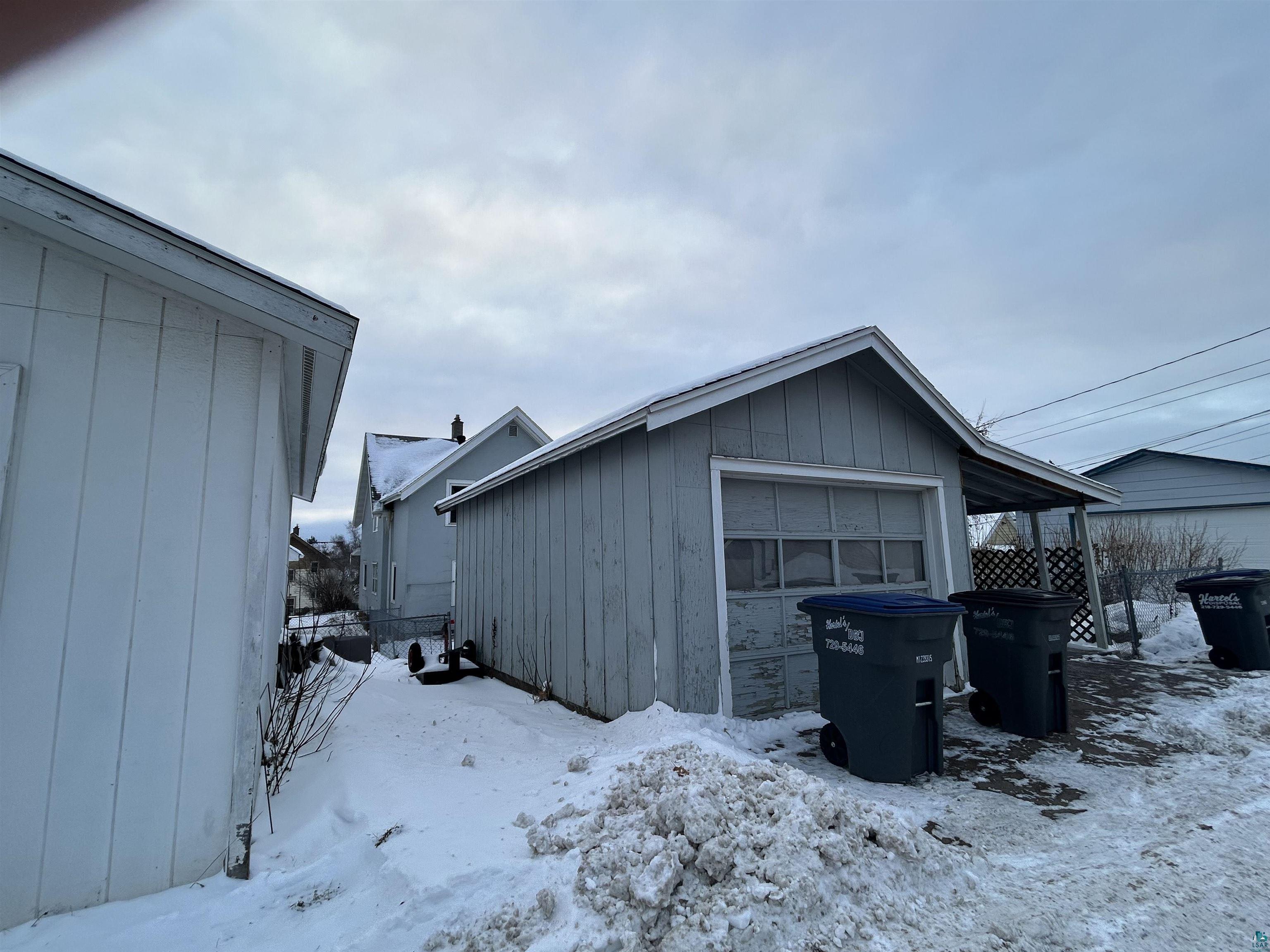 4405 West 7th Street Duluth, MN 55807 - Photo 16 of 18 Snow covered garage featuring a detached garage