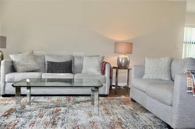 a living room with furniture and a lamp