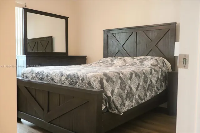 a bedroom with a bed and a mirror