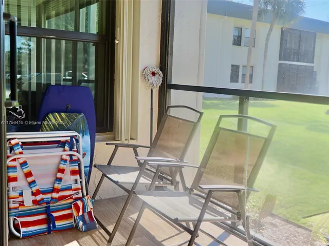 a swimming pool view with a sitting space