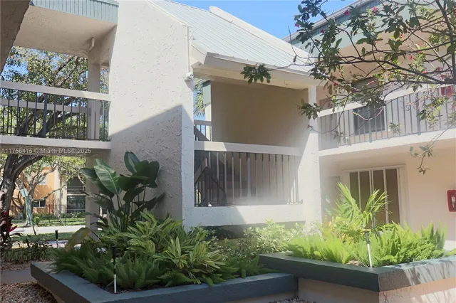 front view of a house with potted plants