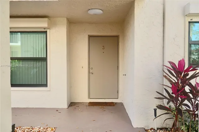 a view of a house with a door and wooden floor