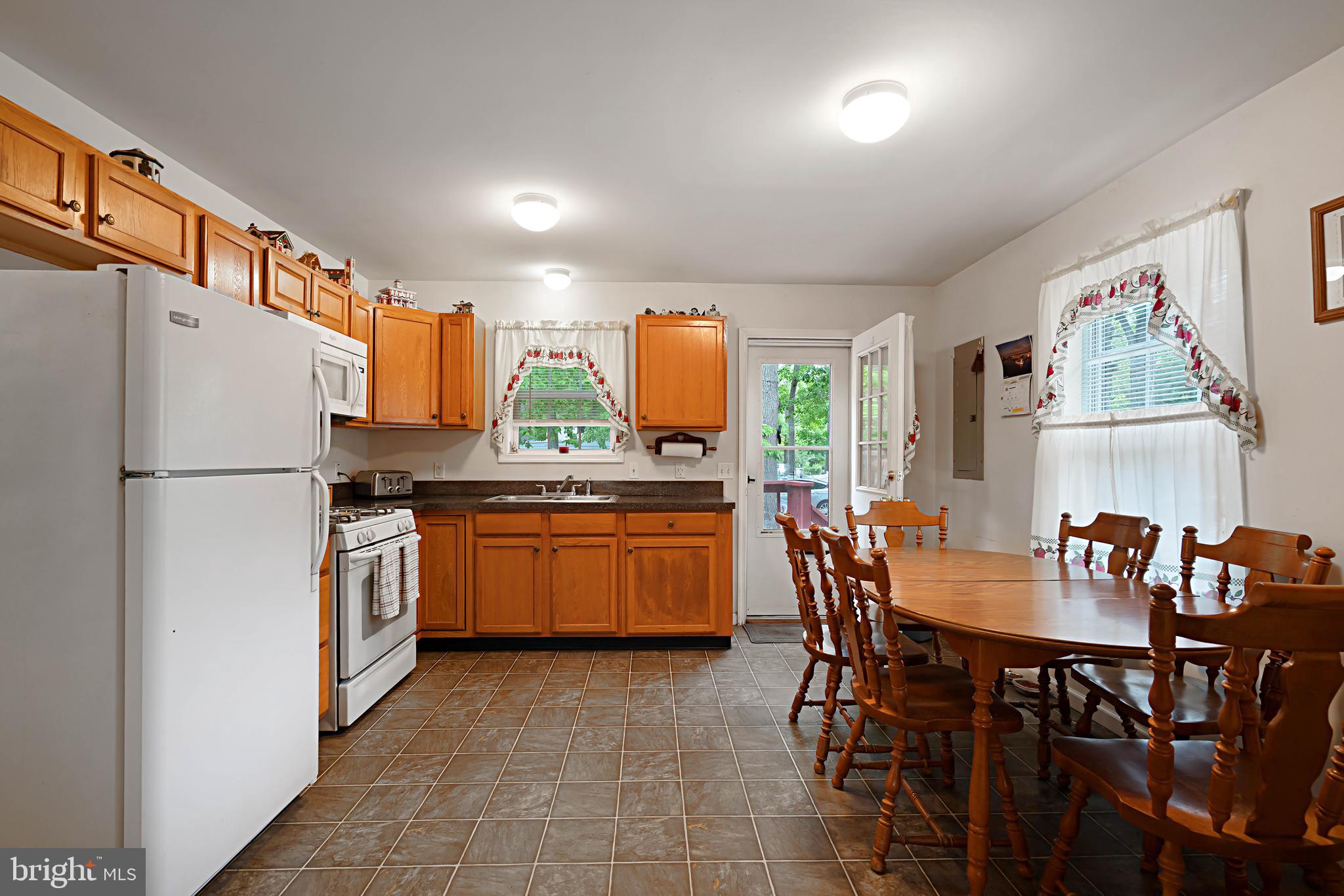 315 Beech Road Millville, NJ 08332 - Photo 5 of 21 a kitchen with stainless steel appliances a refrigerator a stove a dining table and chairs