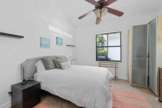 a bedroom with a bed and a tv