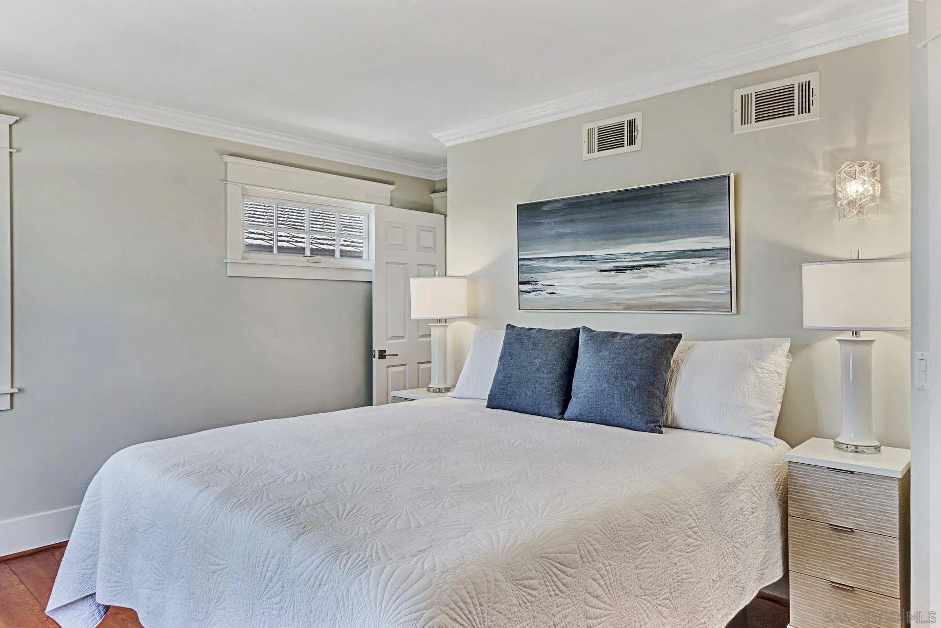 441 A Avenue Coronado, CA 92118 - Photo 18 of 27 a bedroom with a bed and painting on the wall