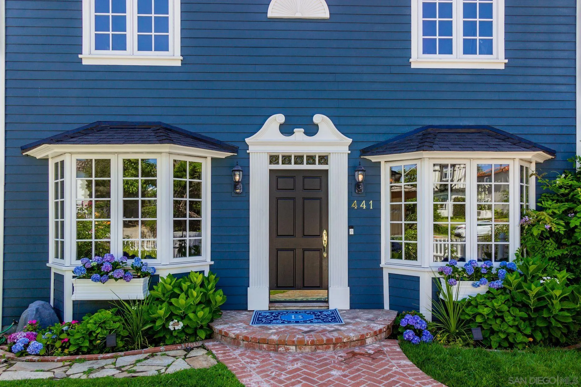 441 A Avenue Coronado, CA 92118 - Photo 5 of 27 a front view of a house with a garden