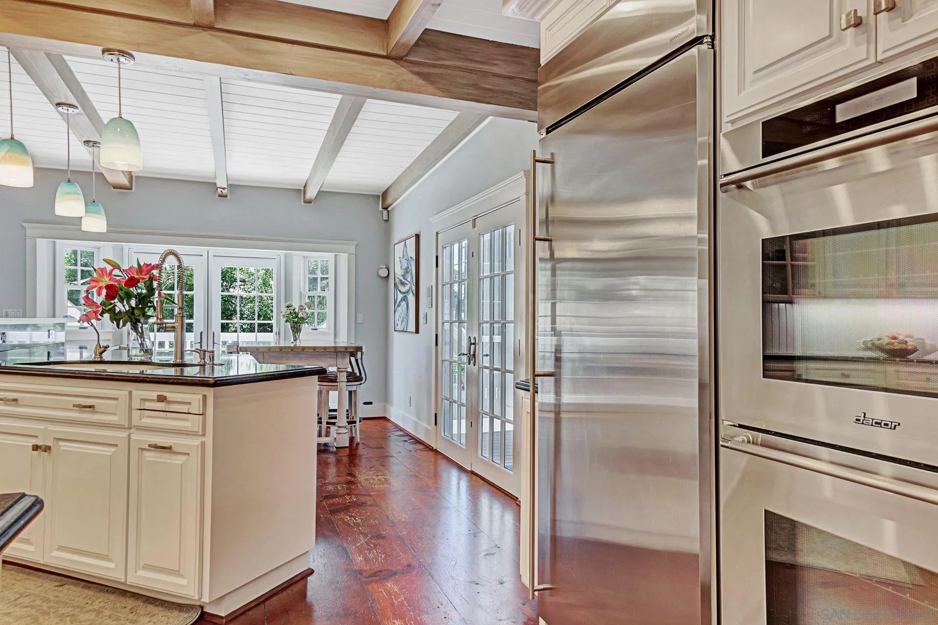 441 A Avenue Coronado, CA 92118 - Photo 9 of 27 a kitchen with stainless steel appliances kitchen island granite countertop a refrigerator and microwave