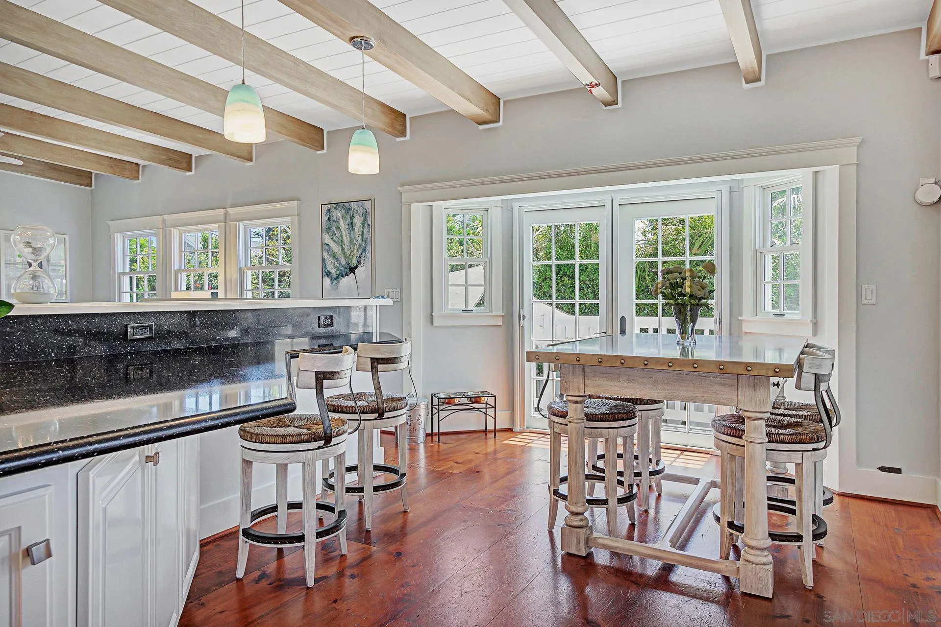 441 A Avenue Coronado, CA 92118 - Photo 10 of 27 a kitchen with a table chairs stove and cabinets