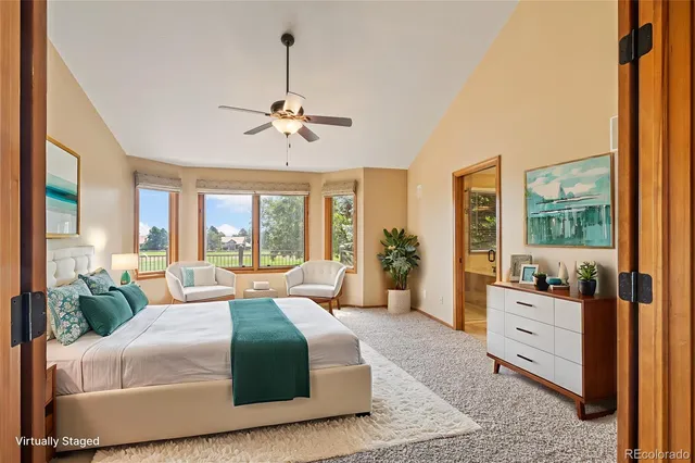 a spacious bedroom with a large bed and a chandelier