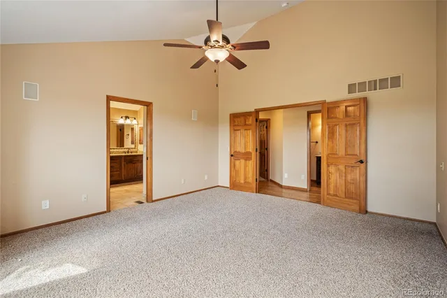 a view of empty room with ceiling fan