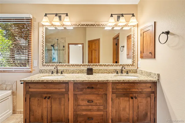 a bathroom with a granite countertop sink mirror and a