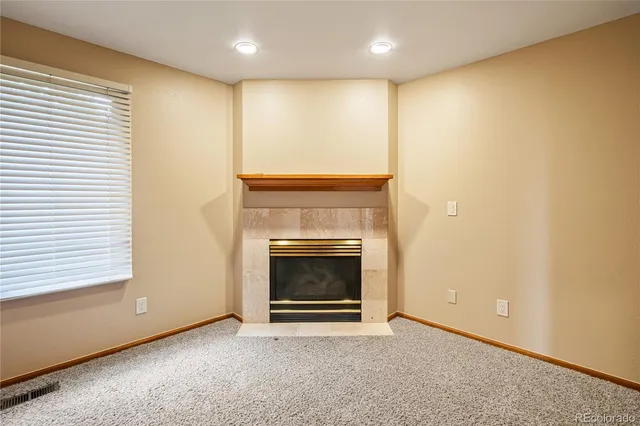 a view of an empty room with a fireplace