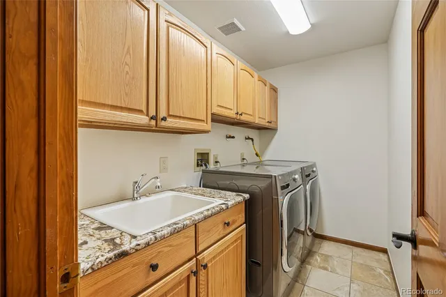 a utility room with a sink a washer and dryer