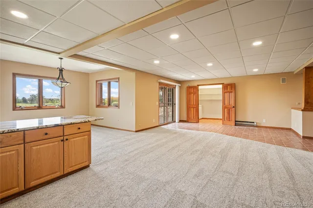 a view of a livingroom with furniture wooden floor and windows