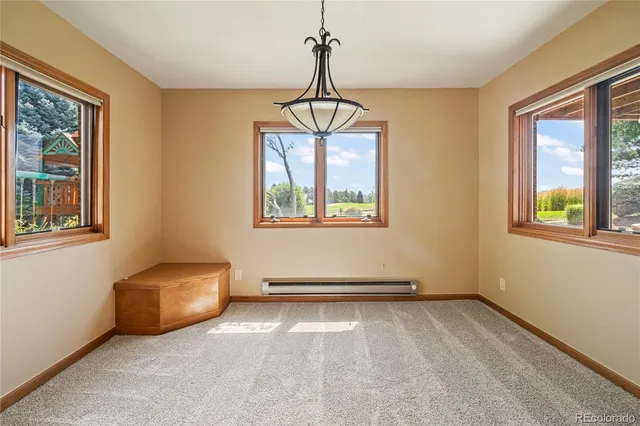a view of a kitchen with a refrigerator a microwave and a table