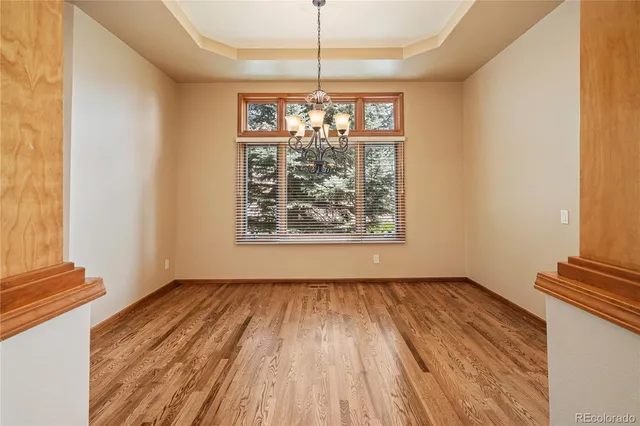 a view of a room with window wooden floor and front door