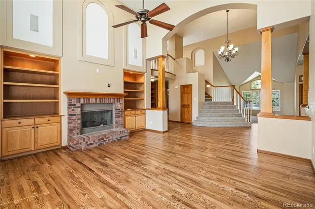 a living room with fireplace furniture and a wooden floor