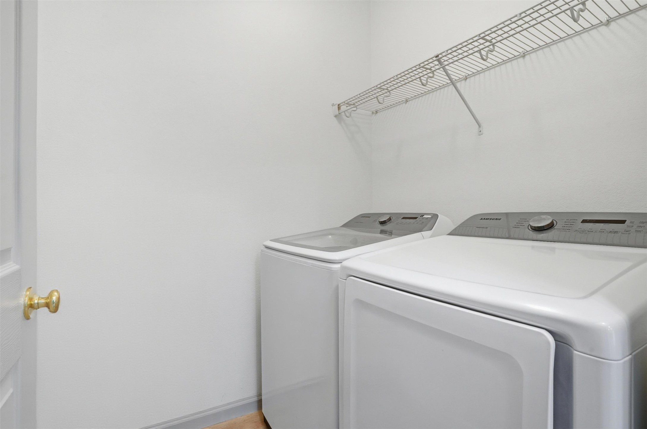 11606 Murchison Street Manor, TX 78653 - Photo 11 of 35 Laundry area with a wire shelf. Washer and Dryer included!