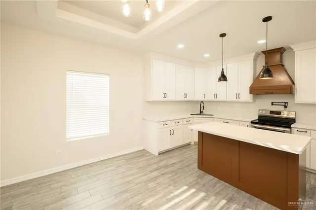 a kitchen with a sink window and cabinets