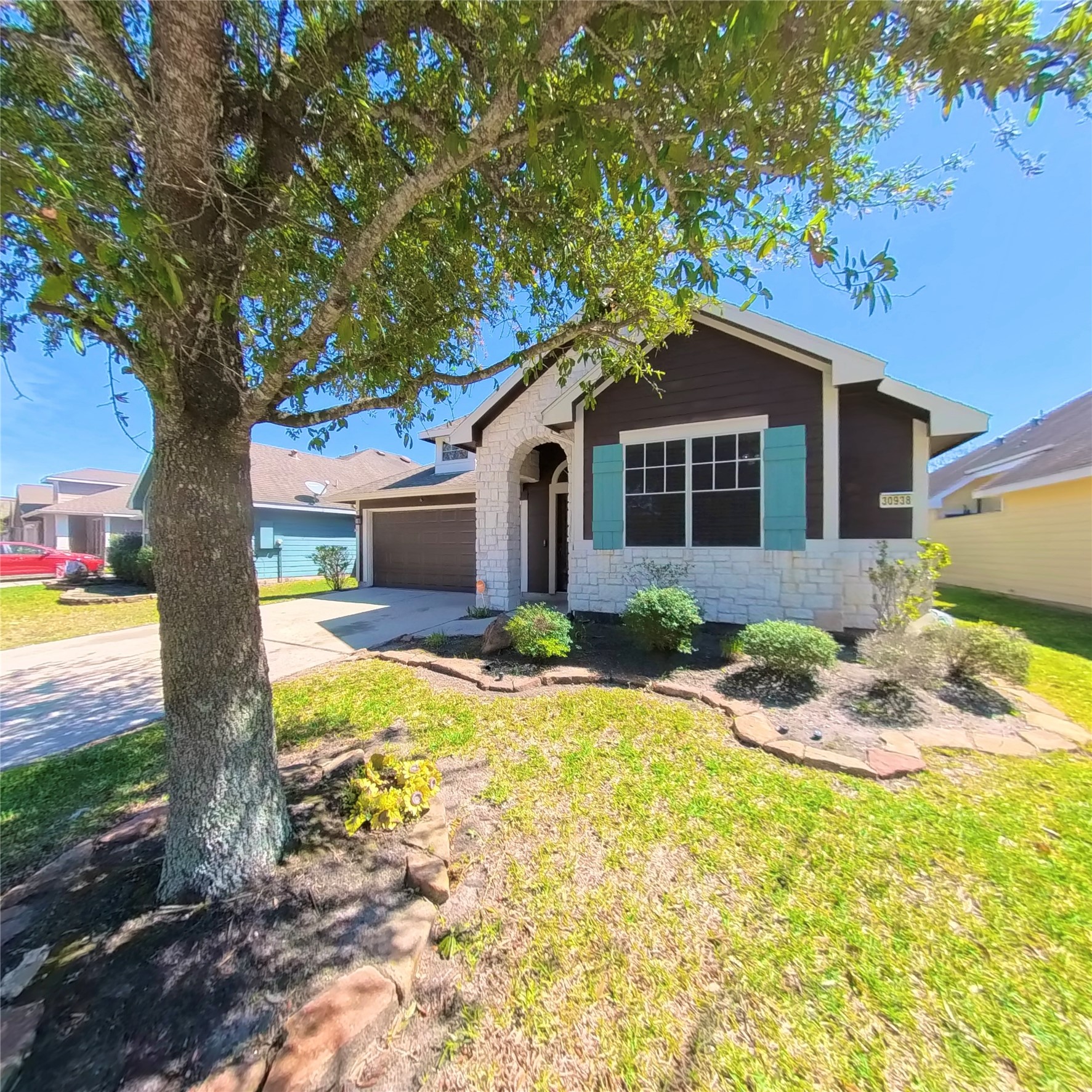 30938 Blue Ridge Park Lane Spring, TX 77386 - Photo 2 of 32 a front view of a house with a yard and garage