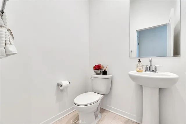 a bathroom with a sink toilet and a mirror