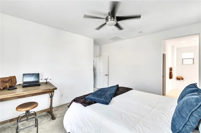 a bedroom with a bed and a chair