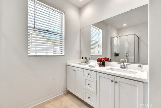 a bathroom with a double vanity sink and mirror