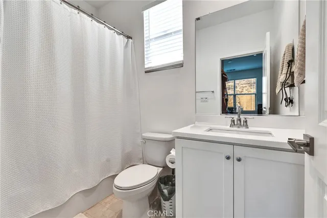 a bathroom with a toilet a sink and a mirror