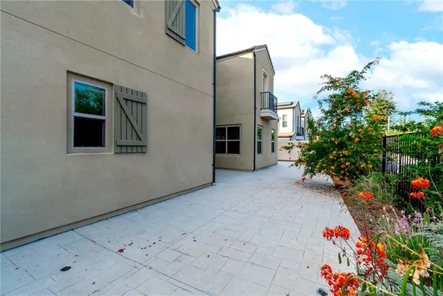 a view of a hallway with a dining table and chairs