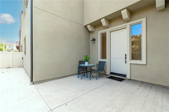 a view of a patio with table and chairs and potted plants