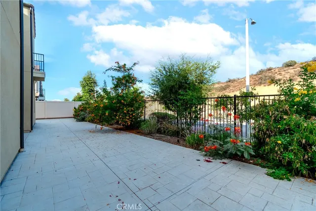 a view of a house with backyard and potted plants
