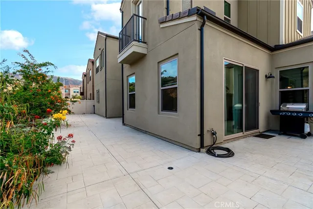 a view of a patio with table and chairs