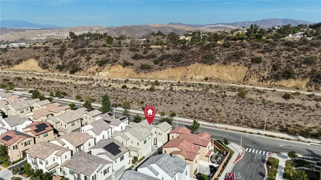 an aerial view of residential houses with street