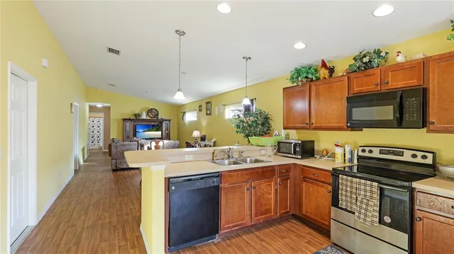 a kitchen with a sink appliances and cabinets