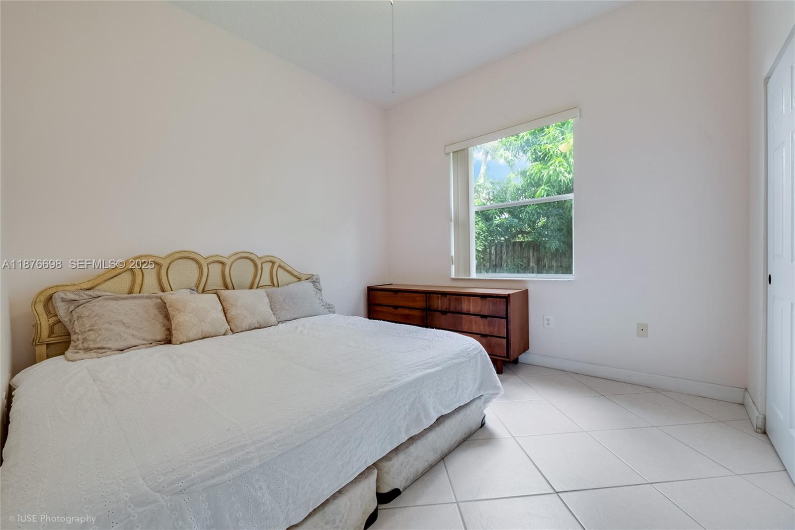 15503 Southwest 151st Street Miami, FL 33196 - Photo 12 of 16 a bedroom with a bed and window
